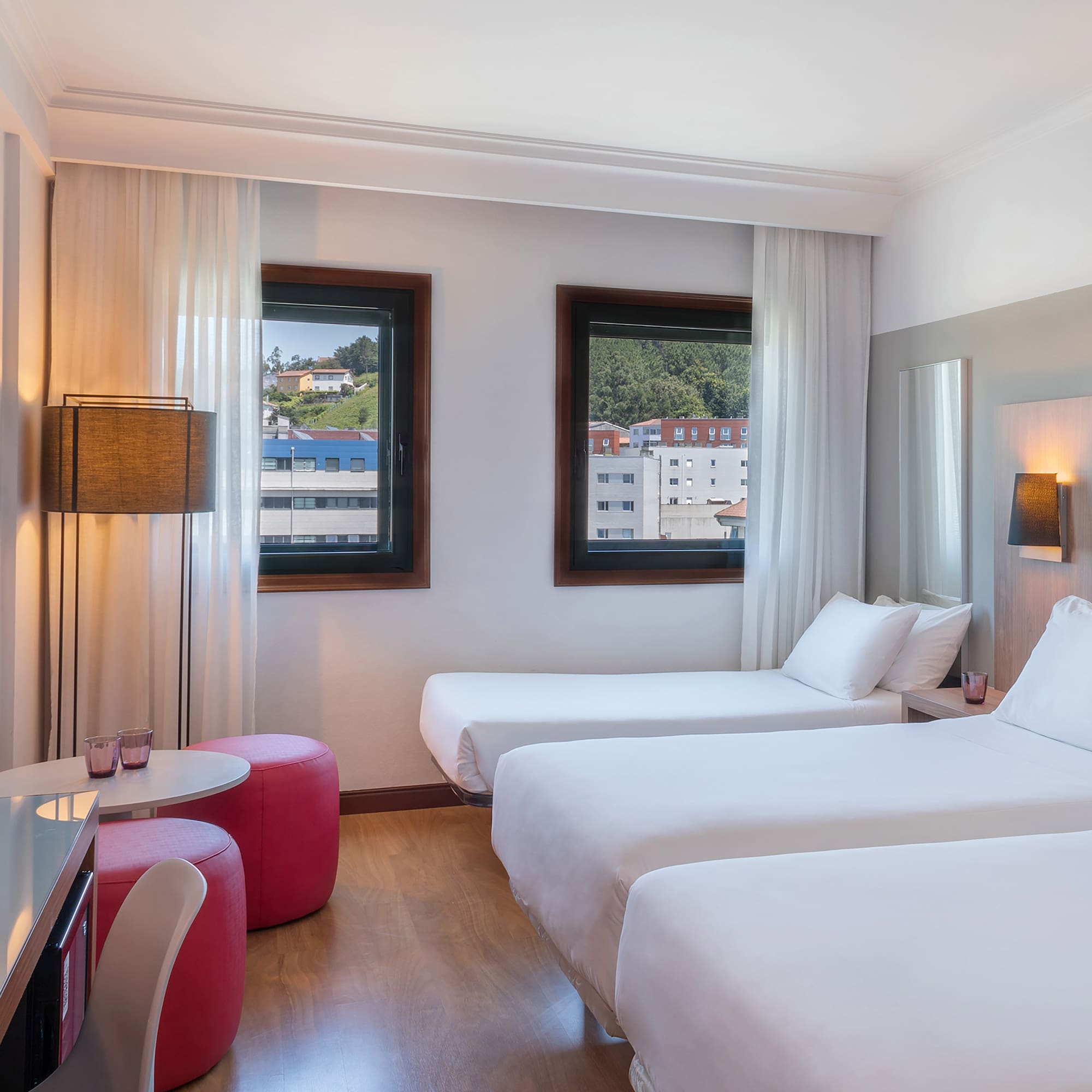 a room with two beds and a table