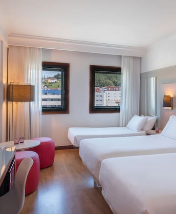 a room with two beds and a table