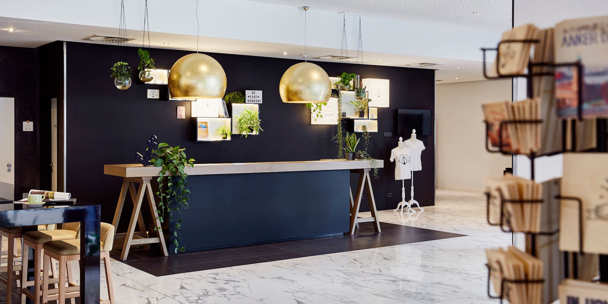 a store with a black wall and gold balls from the ceiling