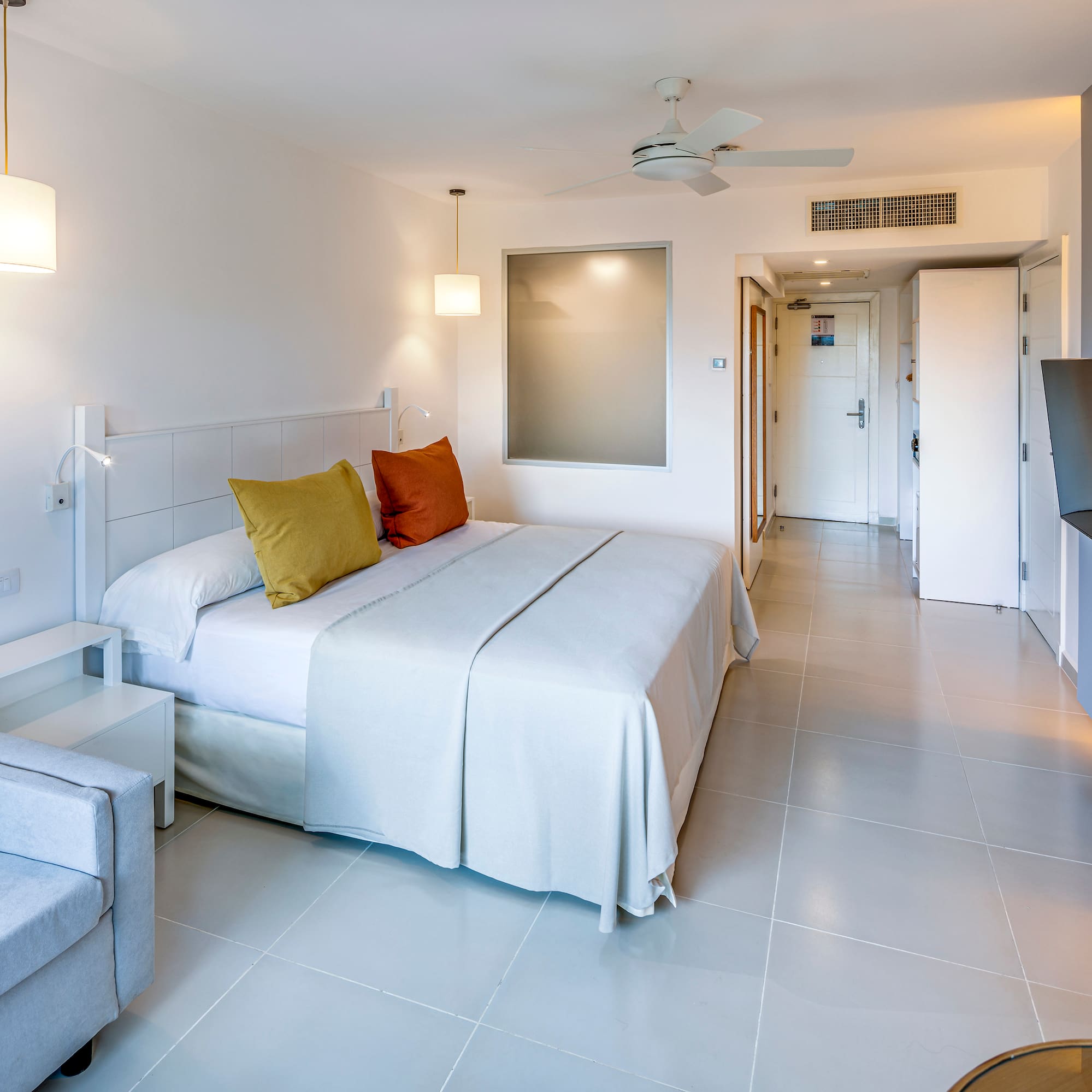 a bedroom with a bed and a television