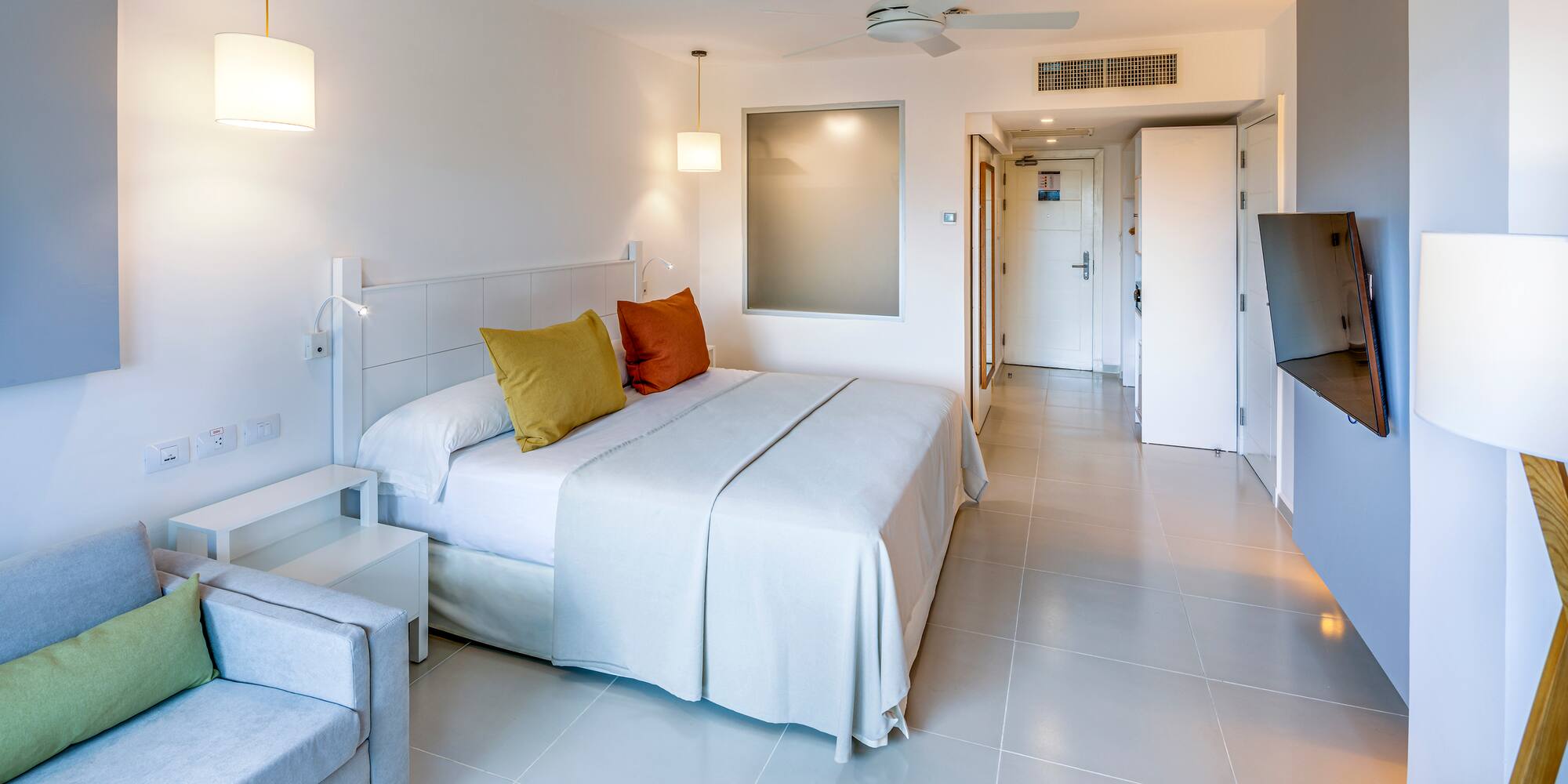 a bedroom with a bed and a television