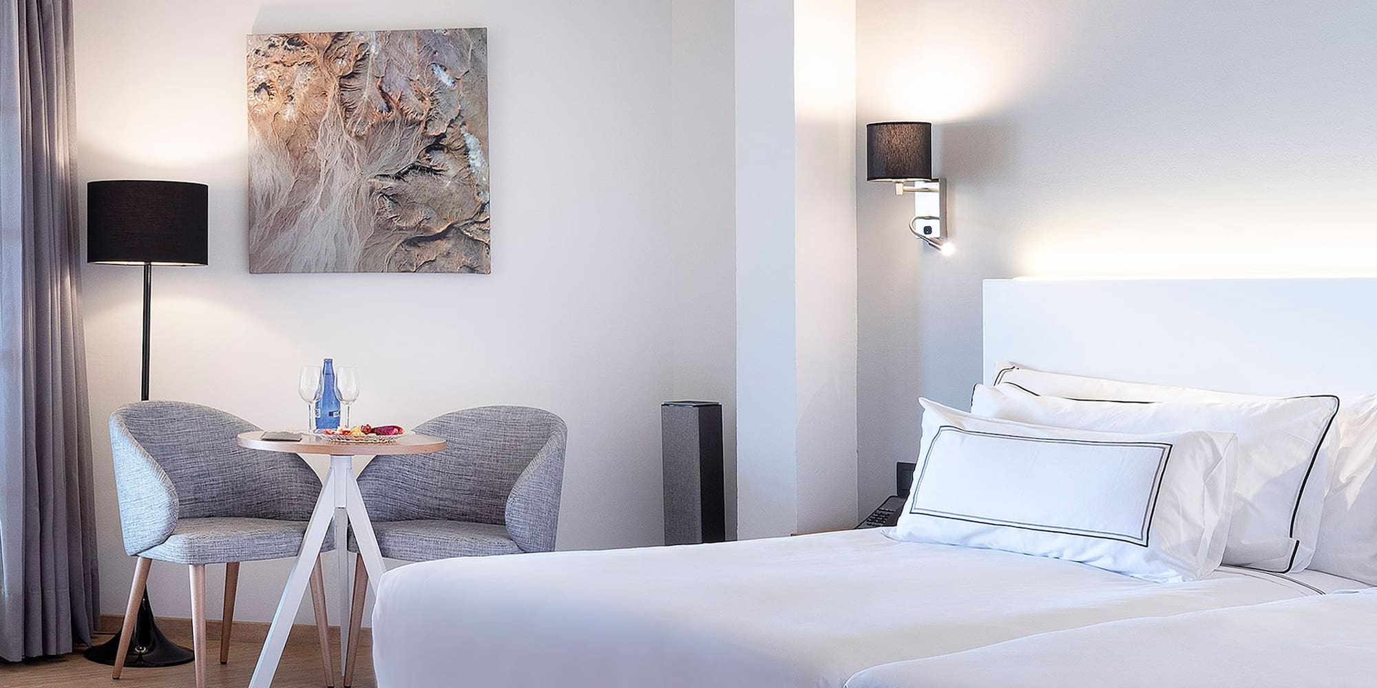 a room with two beds and a table