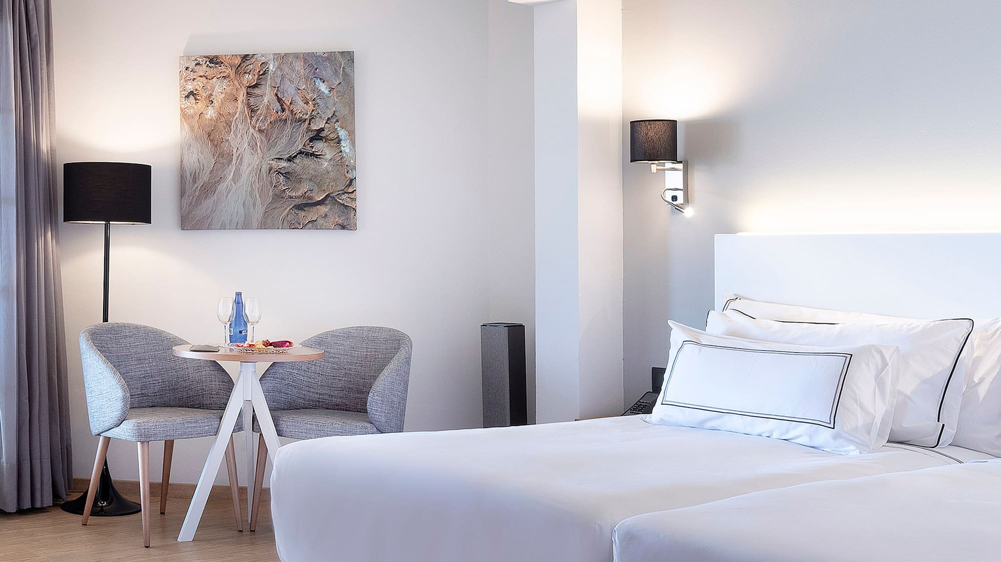 a room with two beds and a table