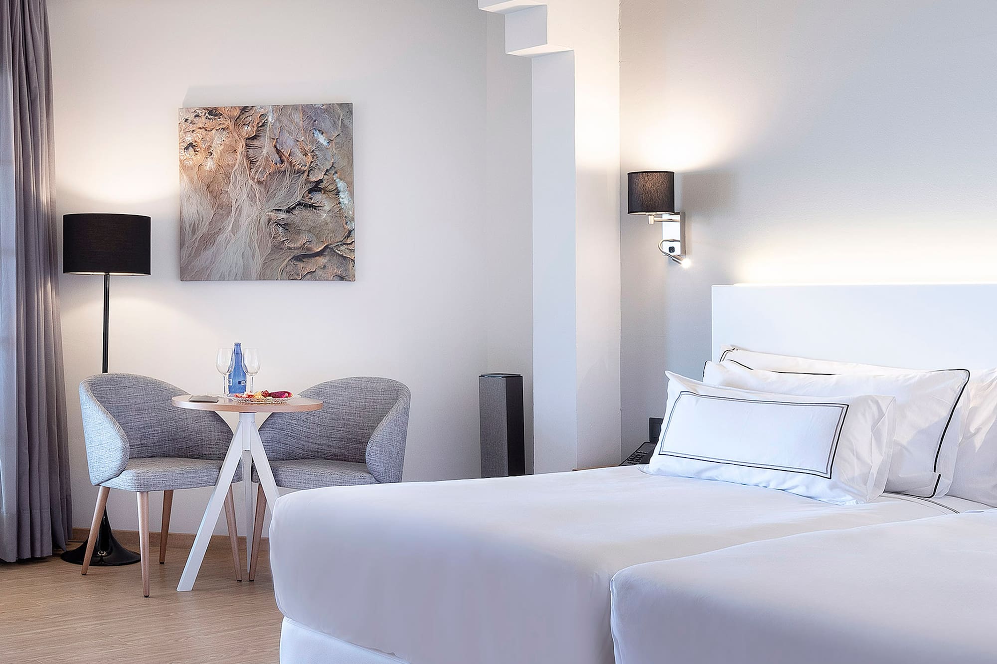 a room with two beds and a table