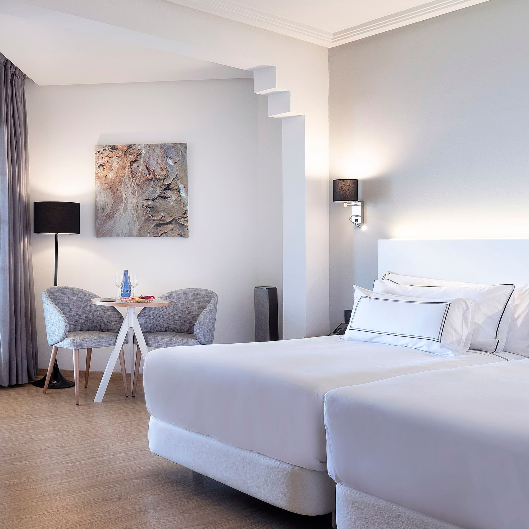 a room with two beds and a table