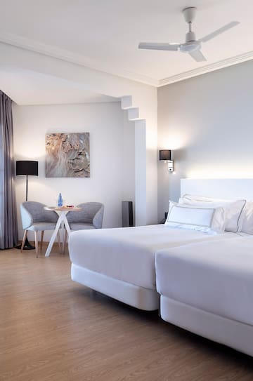 a room with two beds and a table