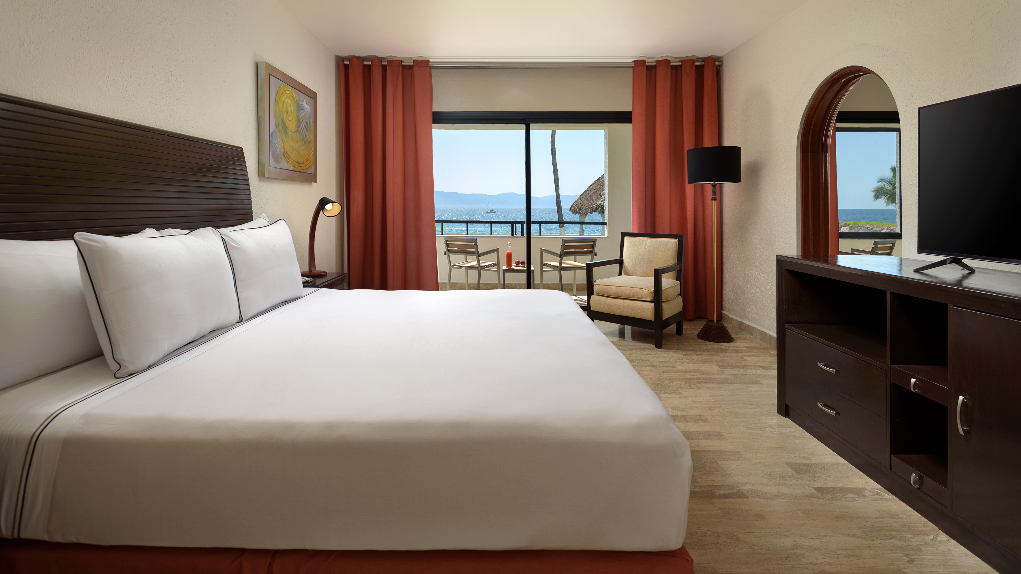 a room with a bed and a television