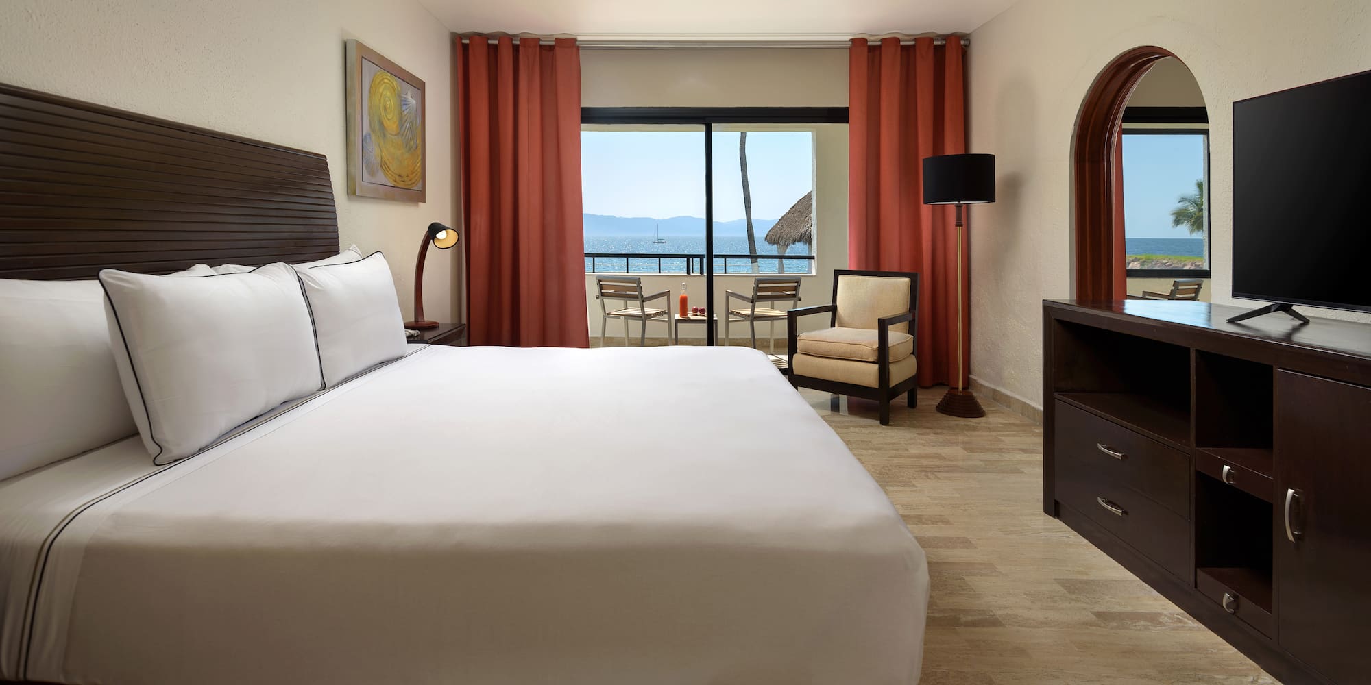 a room with a bed and a television