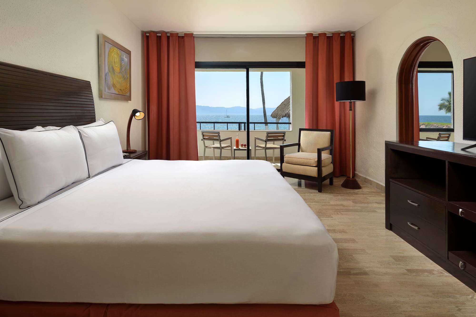 a room with a bed and a television