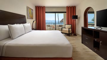 a room with a bed and a television