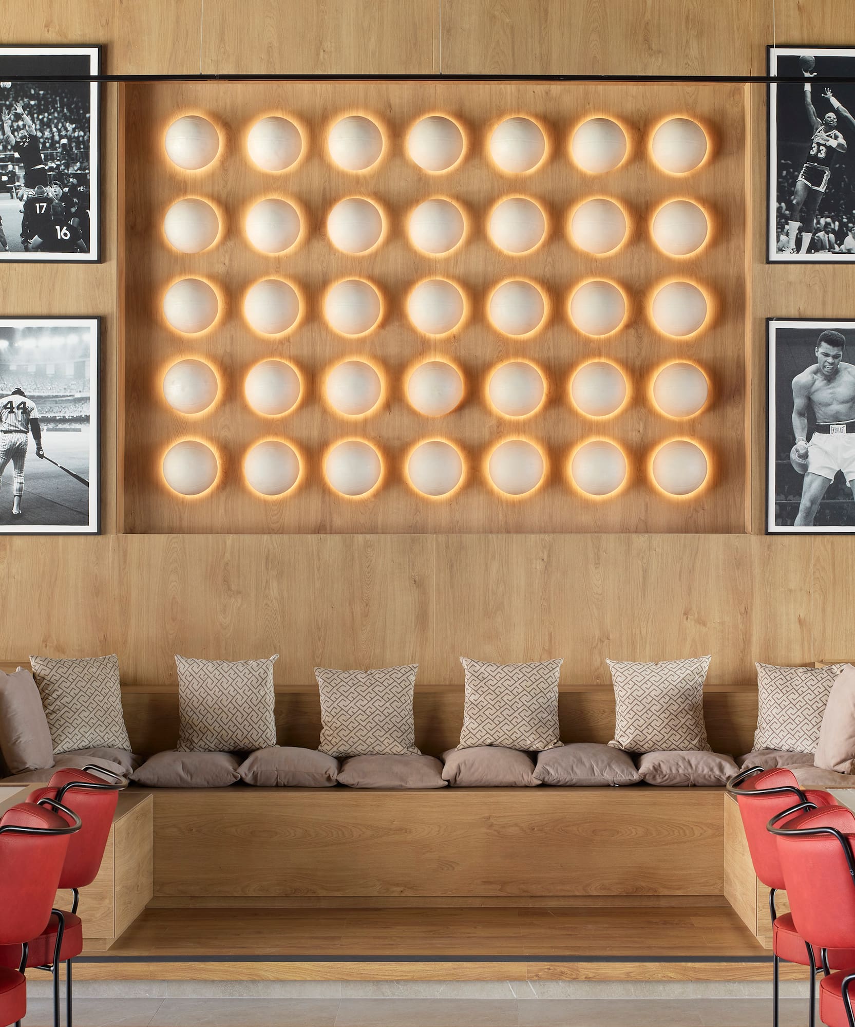 a room with a bench and a wall of pictures