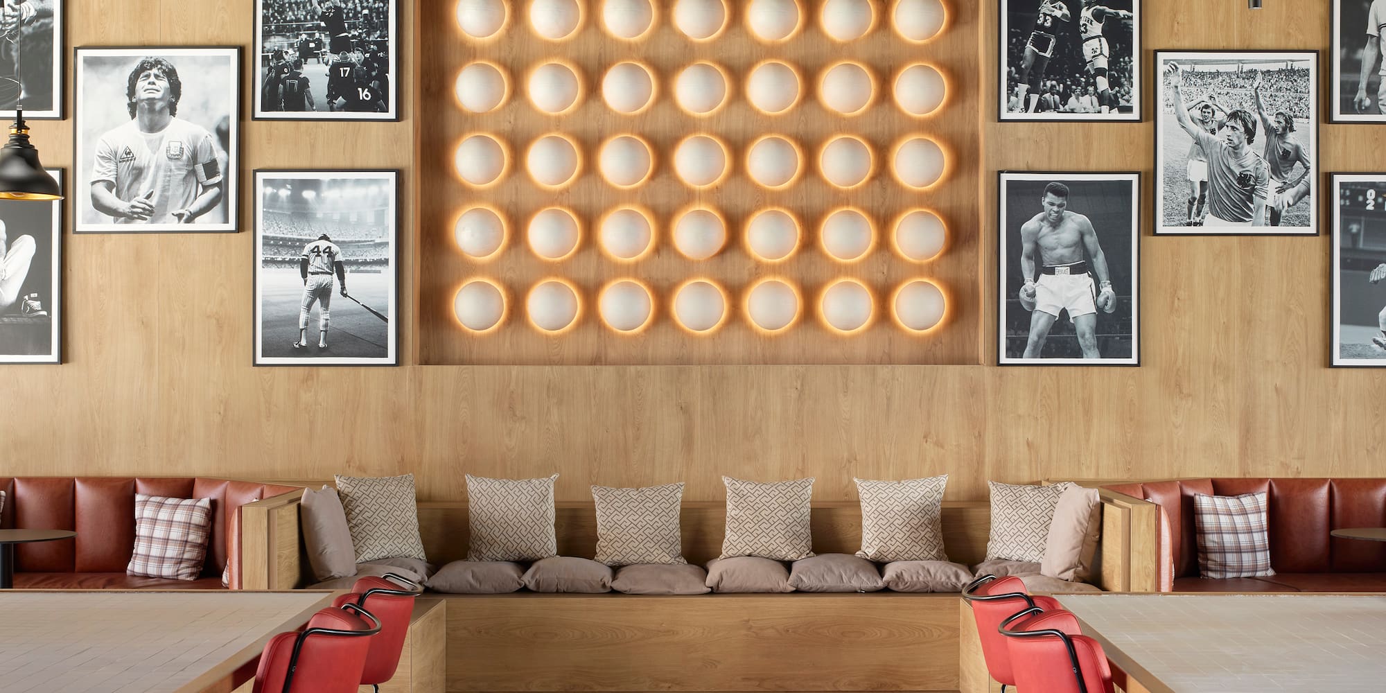 a room with a bench and a wall of pictures