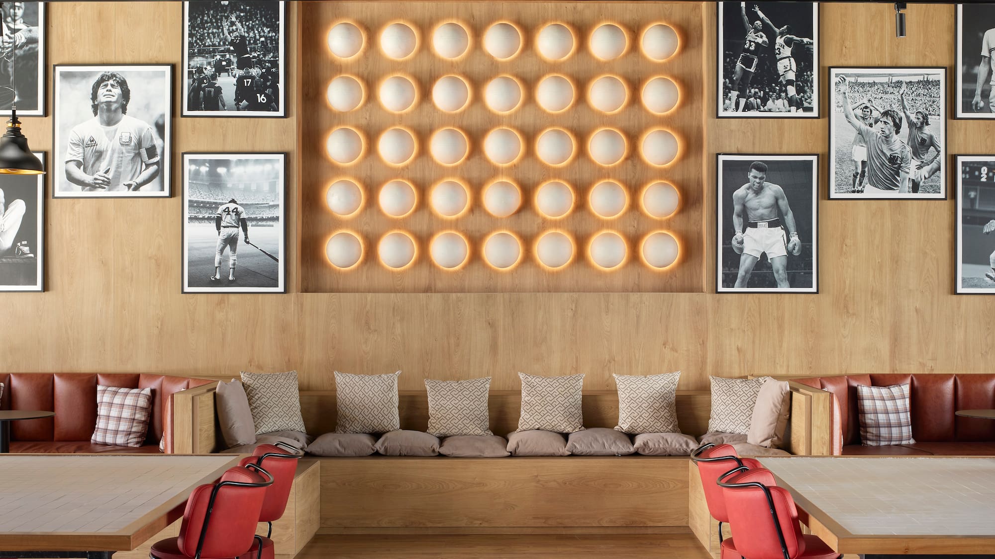 a room with a bench and a wall of pictures