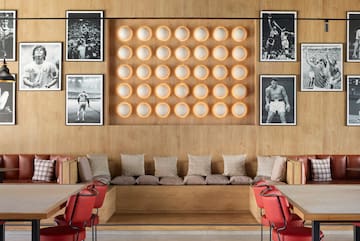 a room with a bench and a wall of pictures