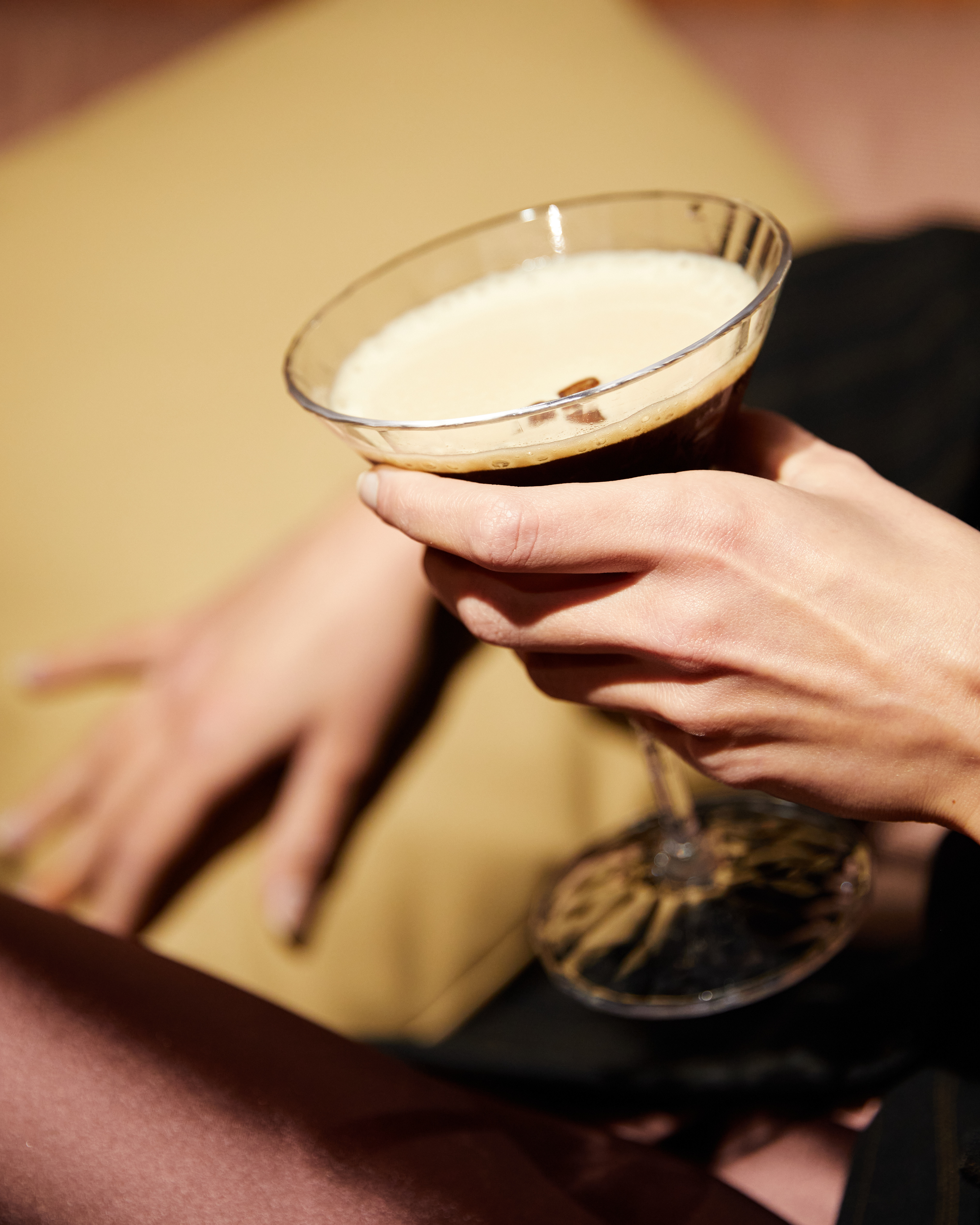 a person holding a glass of liquid