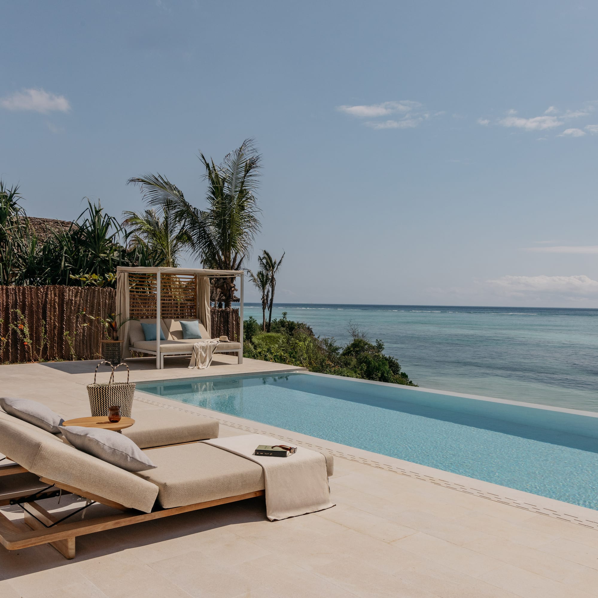 a pool with a lounge chair and a table