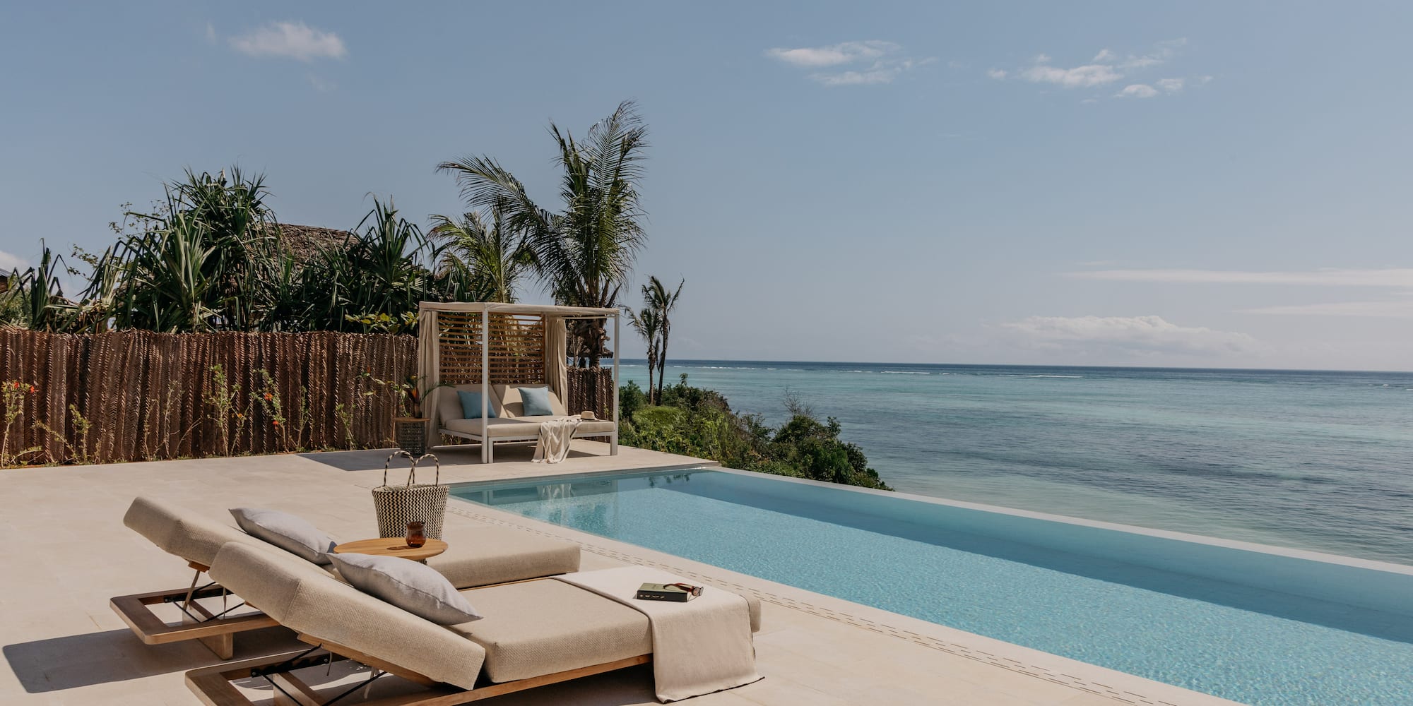 a pool with a lounge chair and a table