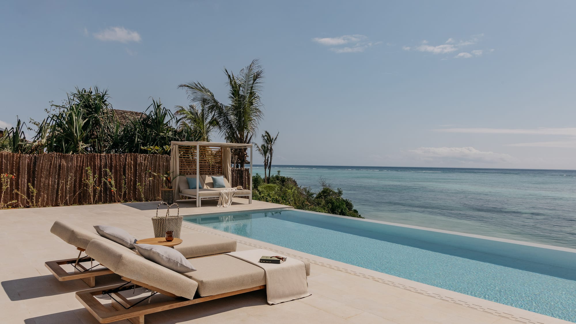 a pool with a lounge chair and a table
