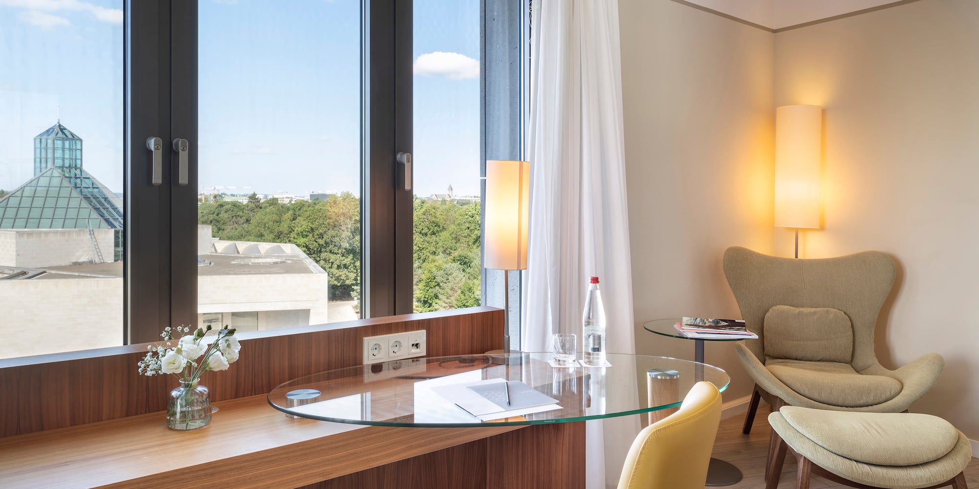 a room with a glass table and chairs