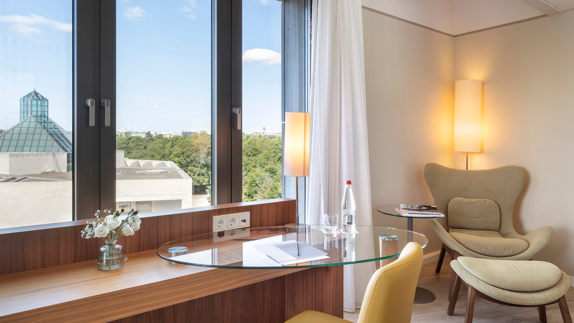 a room with a glass table and chairs