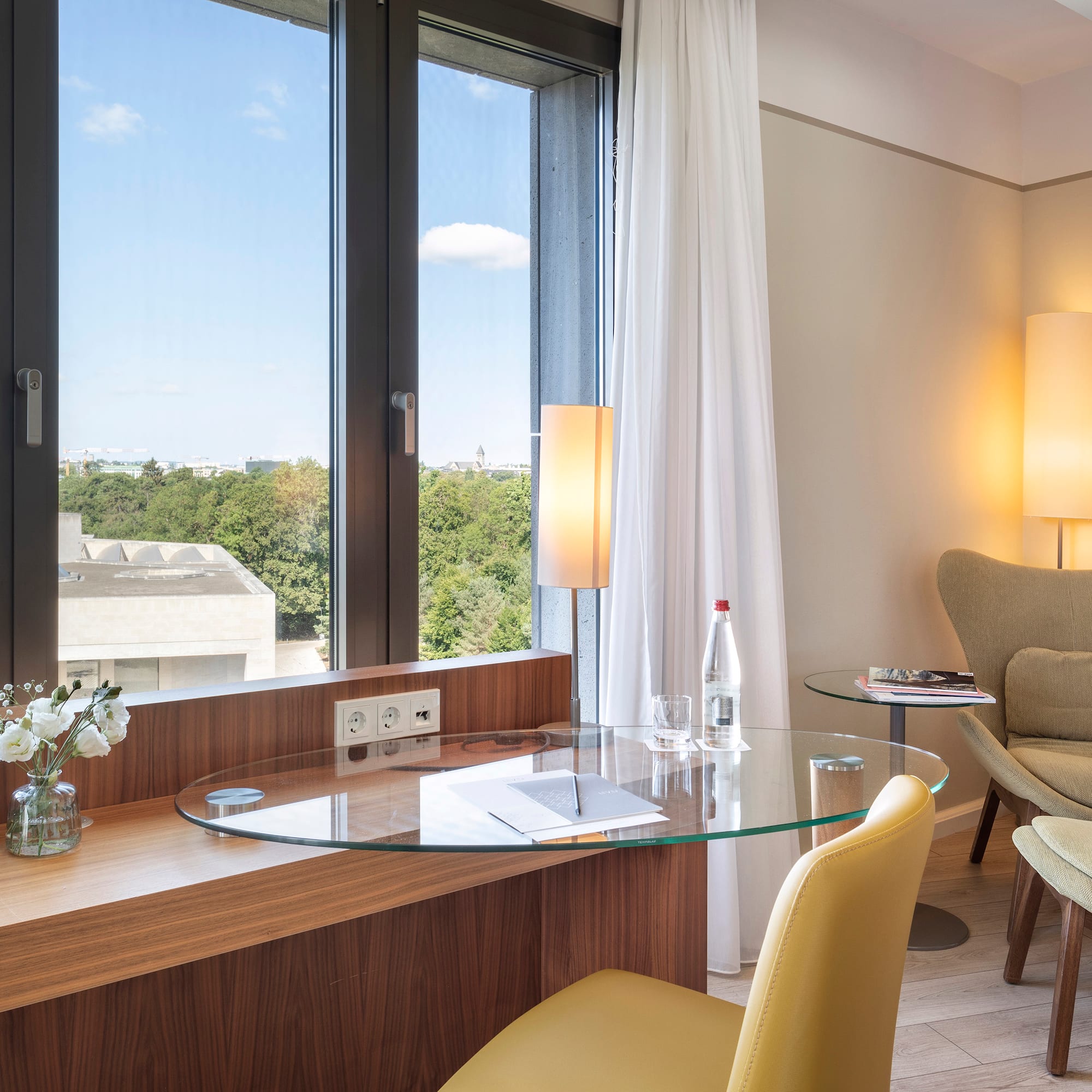 a room with a glass table and chairs