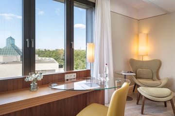 a room with a glass table and chairs