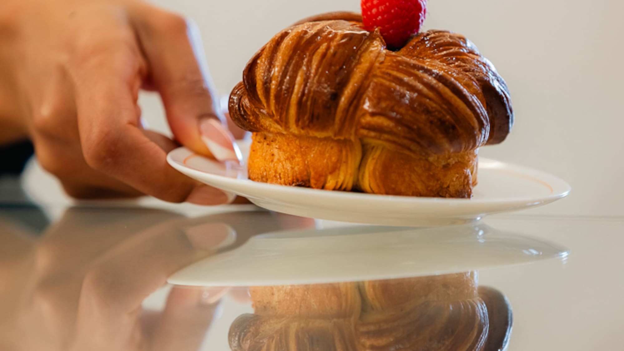 a hand holding a plate of food