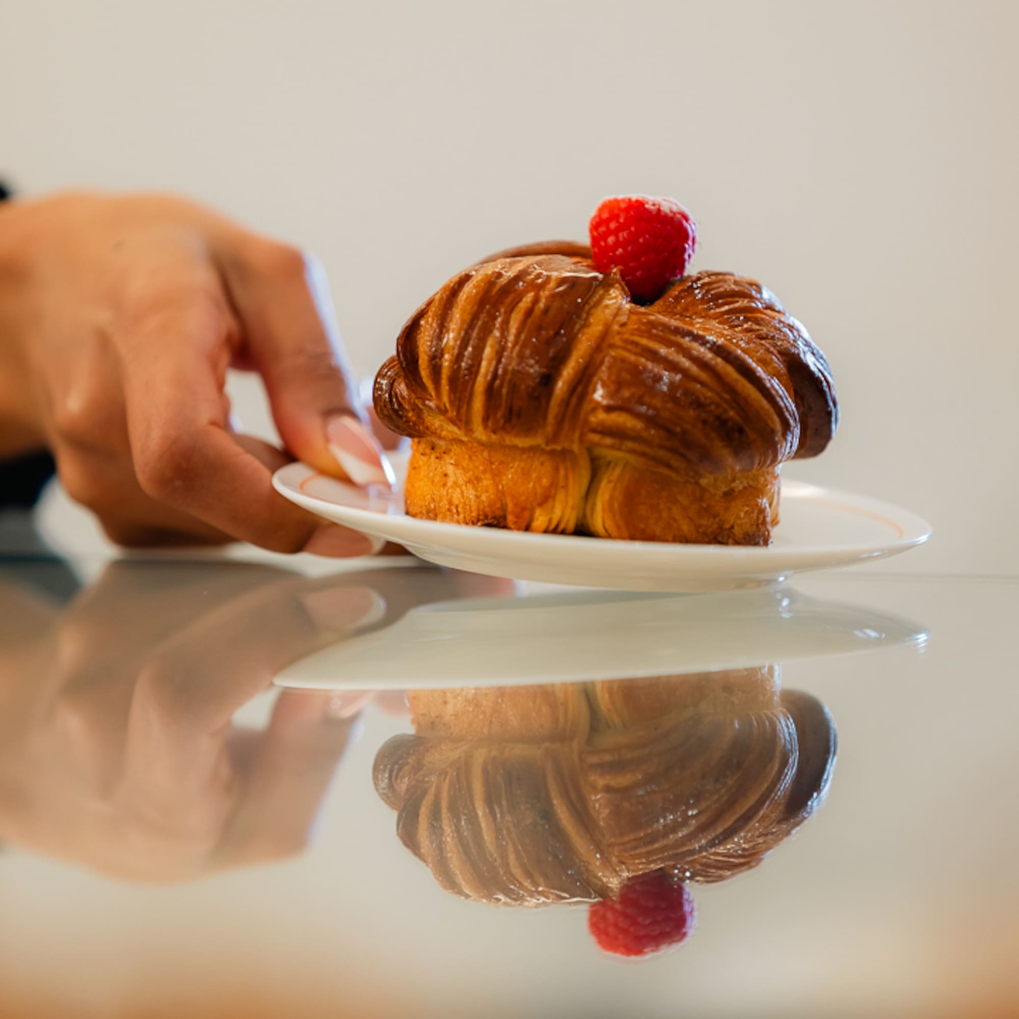 a hand holding a plate of food