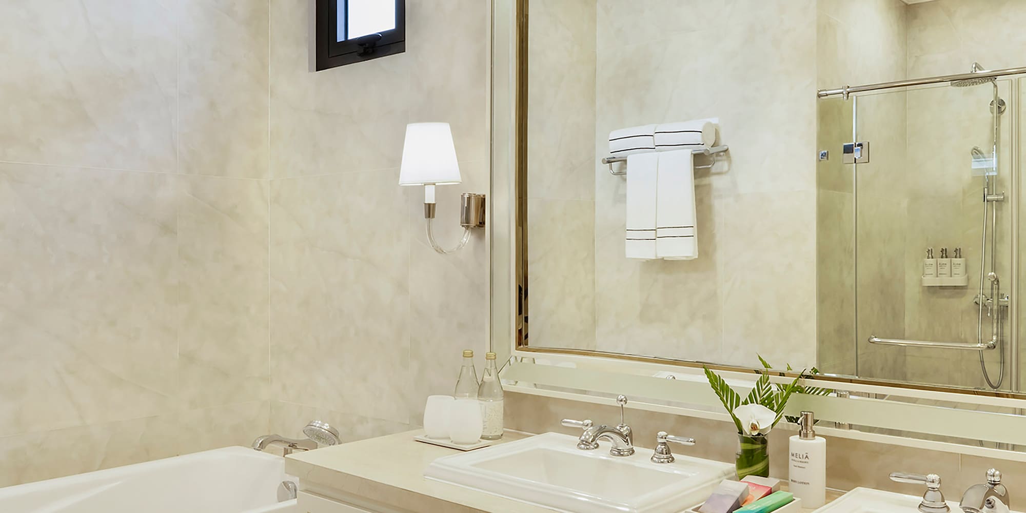 a bathroom with a large mirror and sink