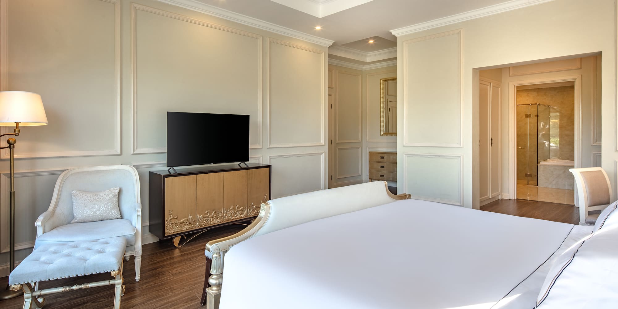 a bedroom with a bed and a tv