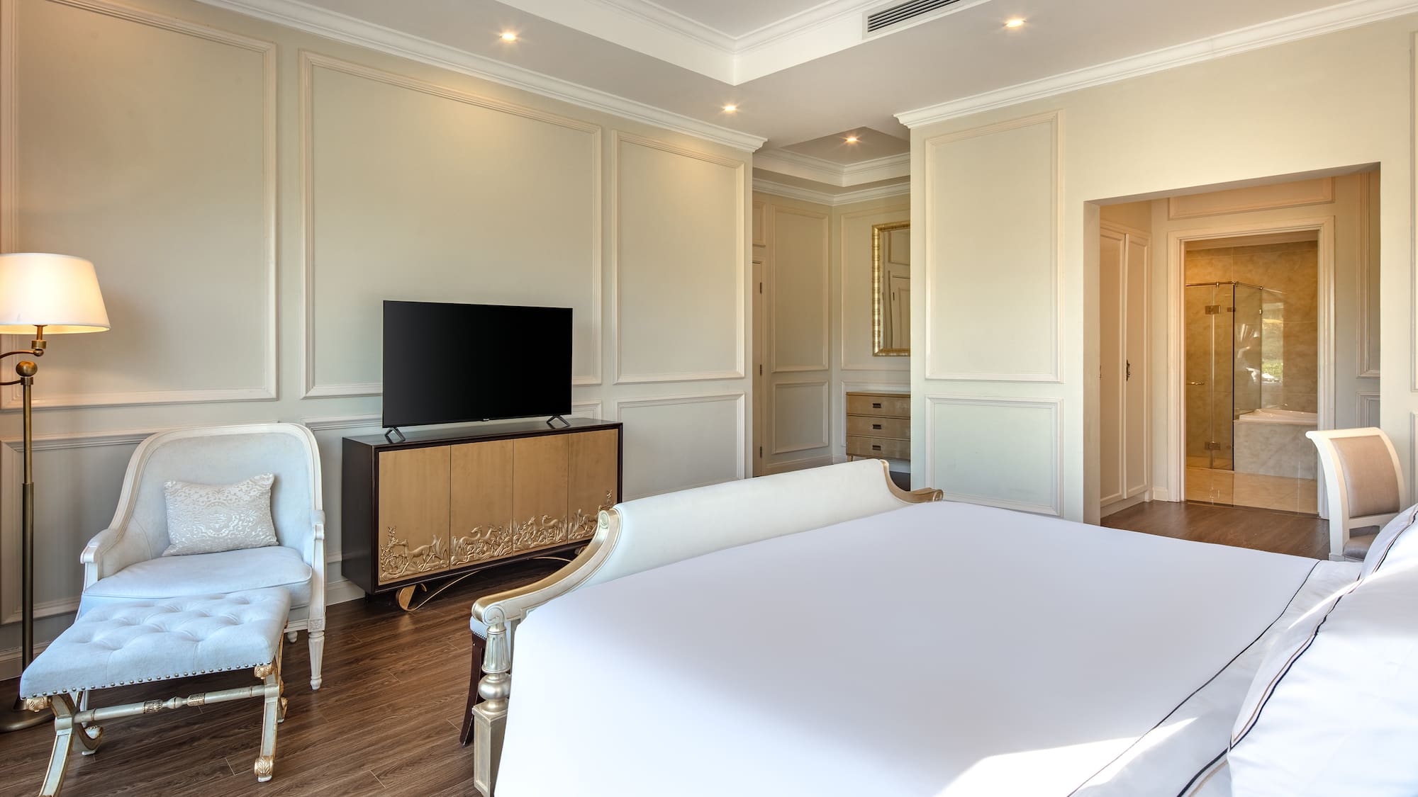 a bedroom with a bed and a tv