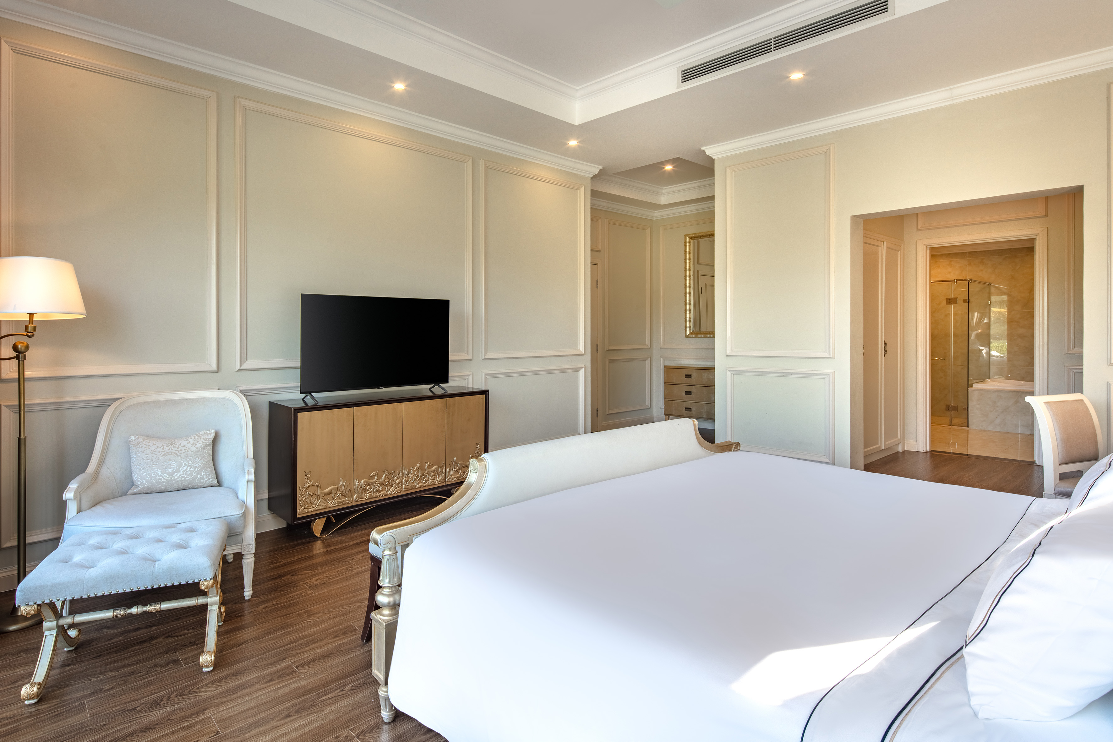 a bedroom with a bed and a tv