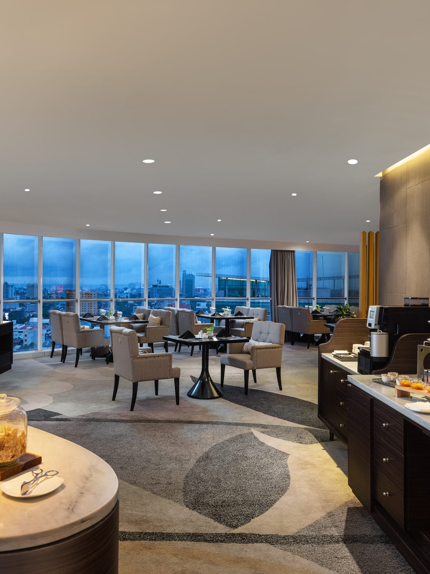 a room with a buffet and a view of a city