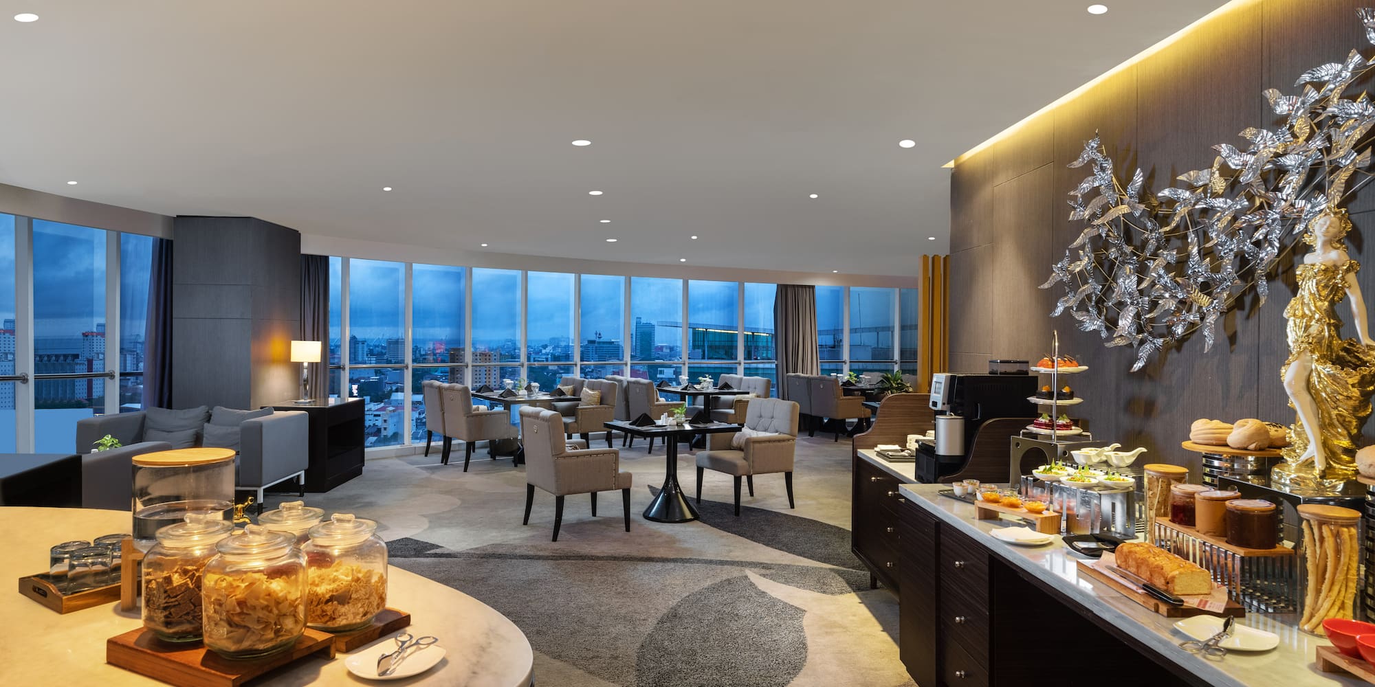 a room with a buffet and a view of a city