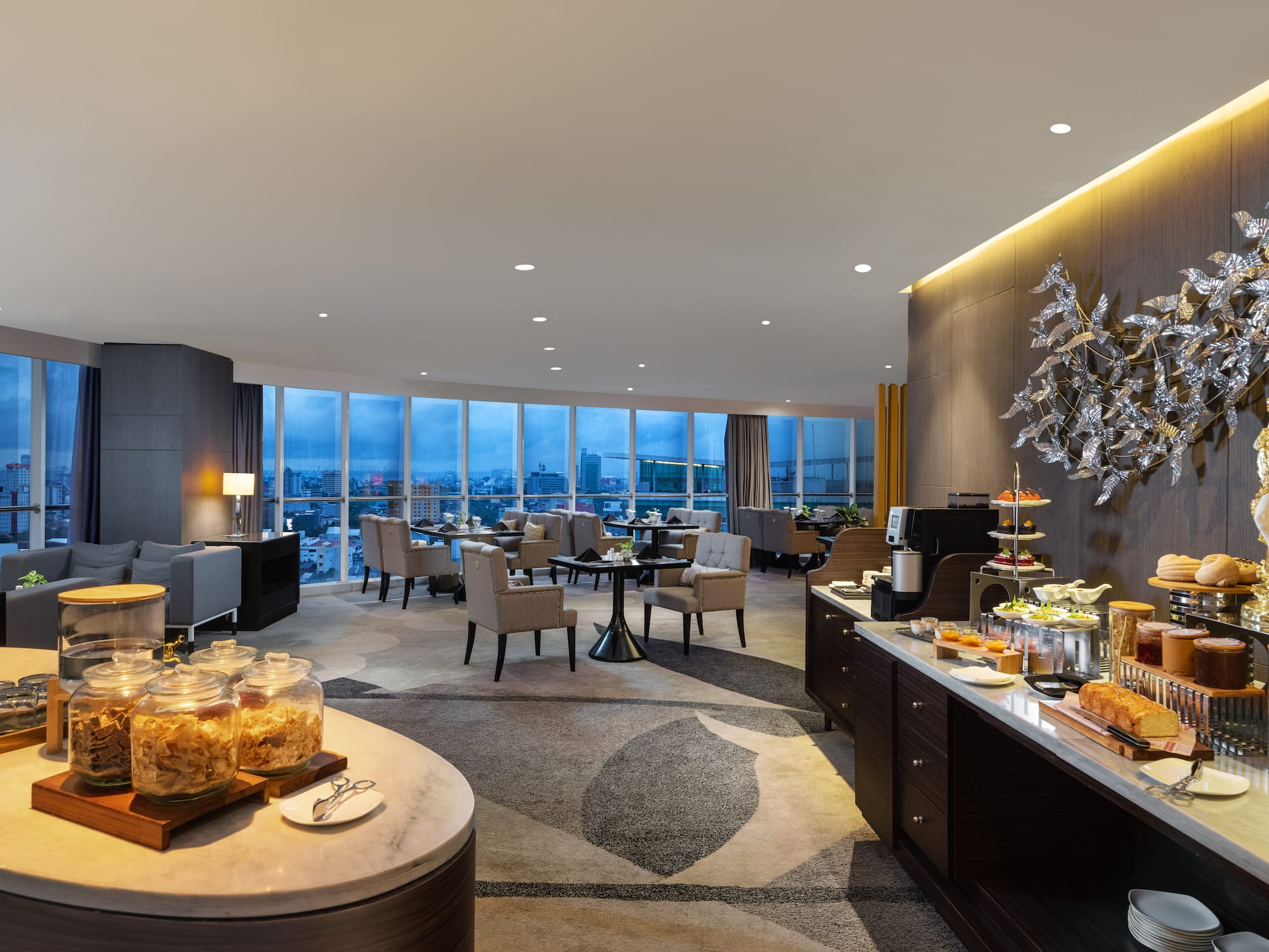 a room with a buffet and a view of a city