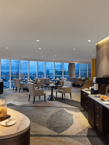 a room with a buffet and a view of a city