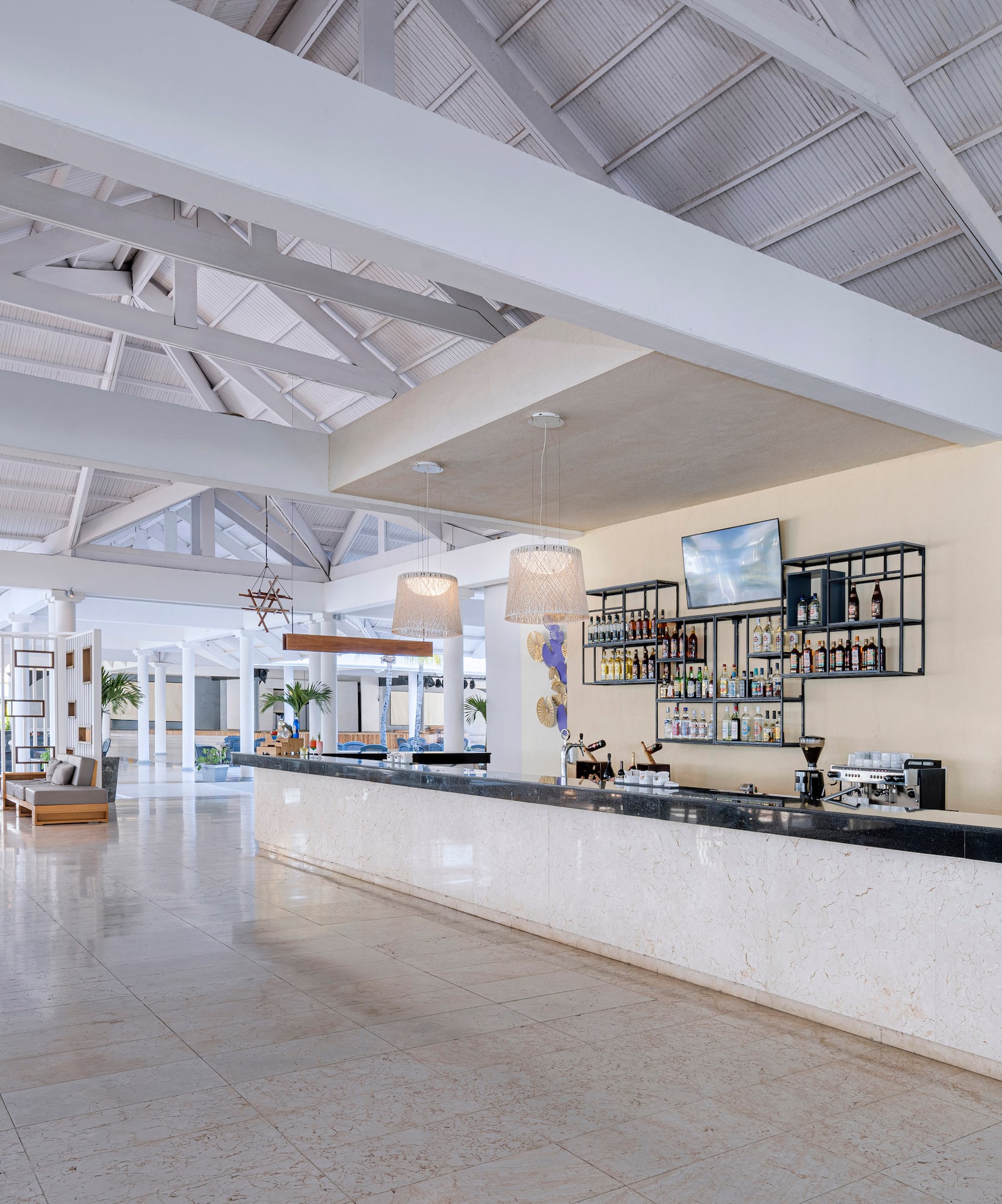 a large white room with a bar and a large white ceiling