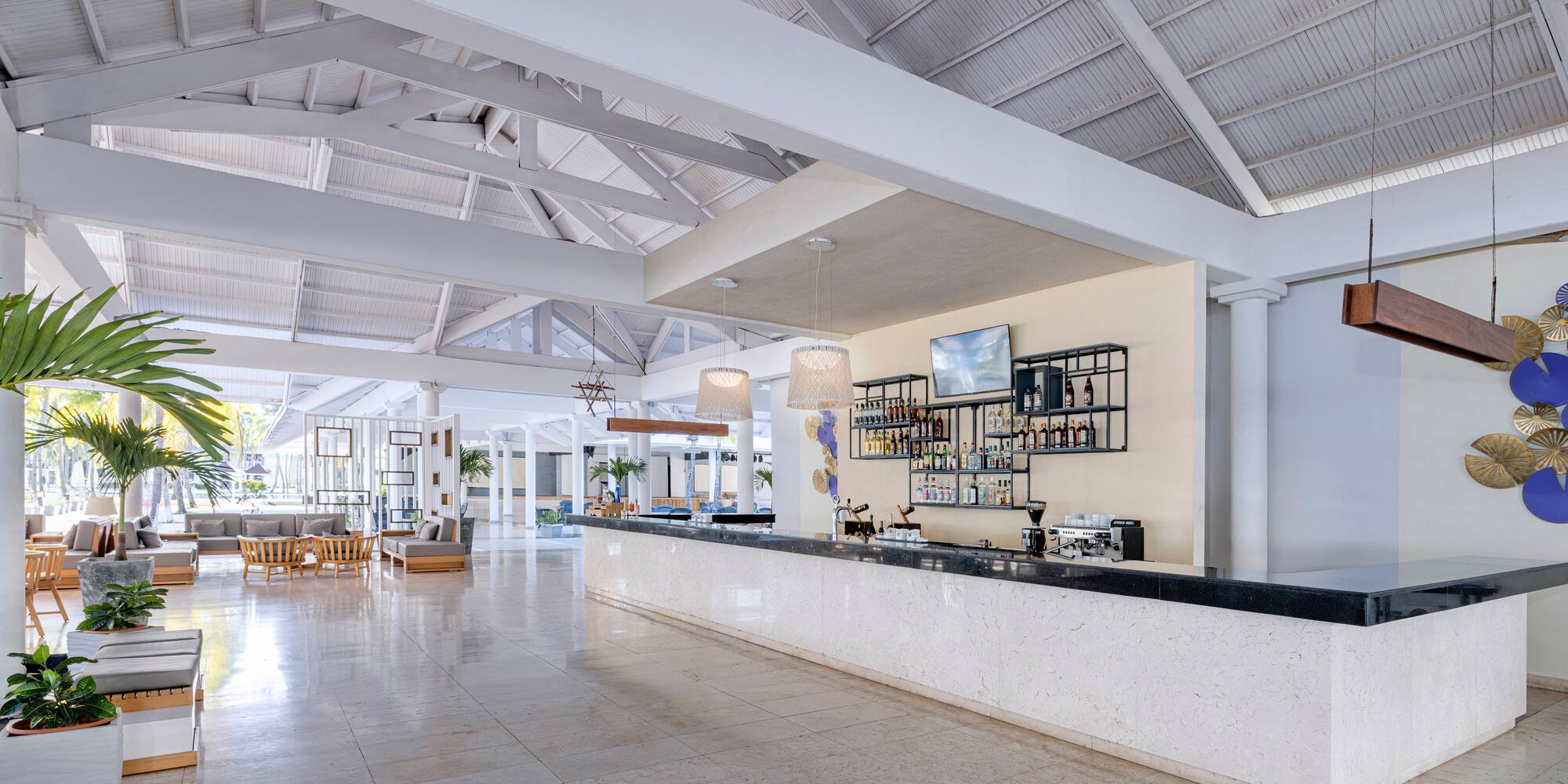 a large white room with a bar and a large white ceiling
