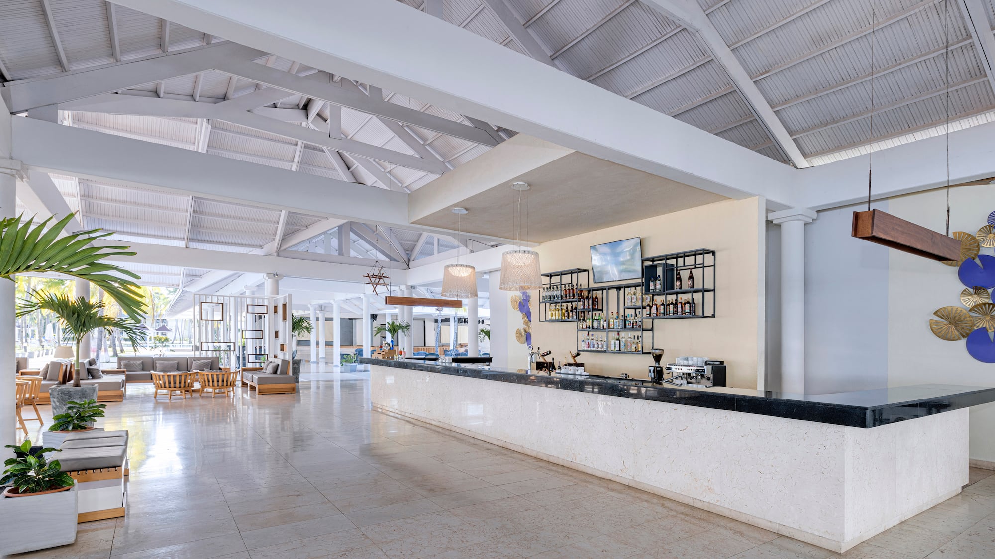 a large white room with a bar and a large white ceiling