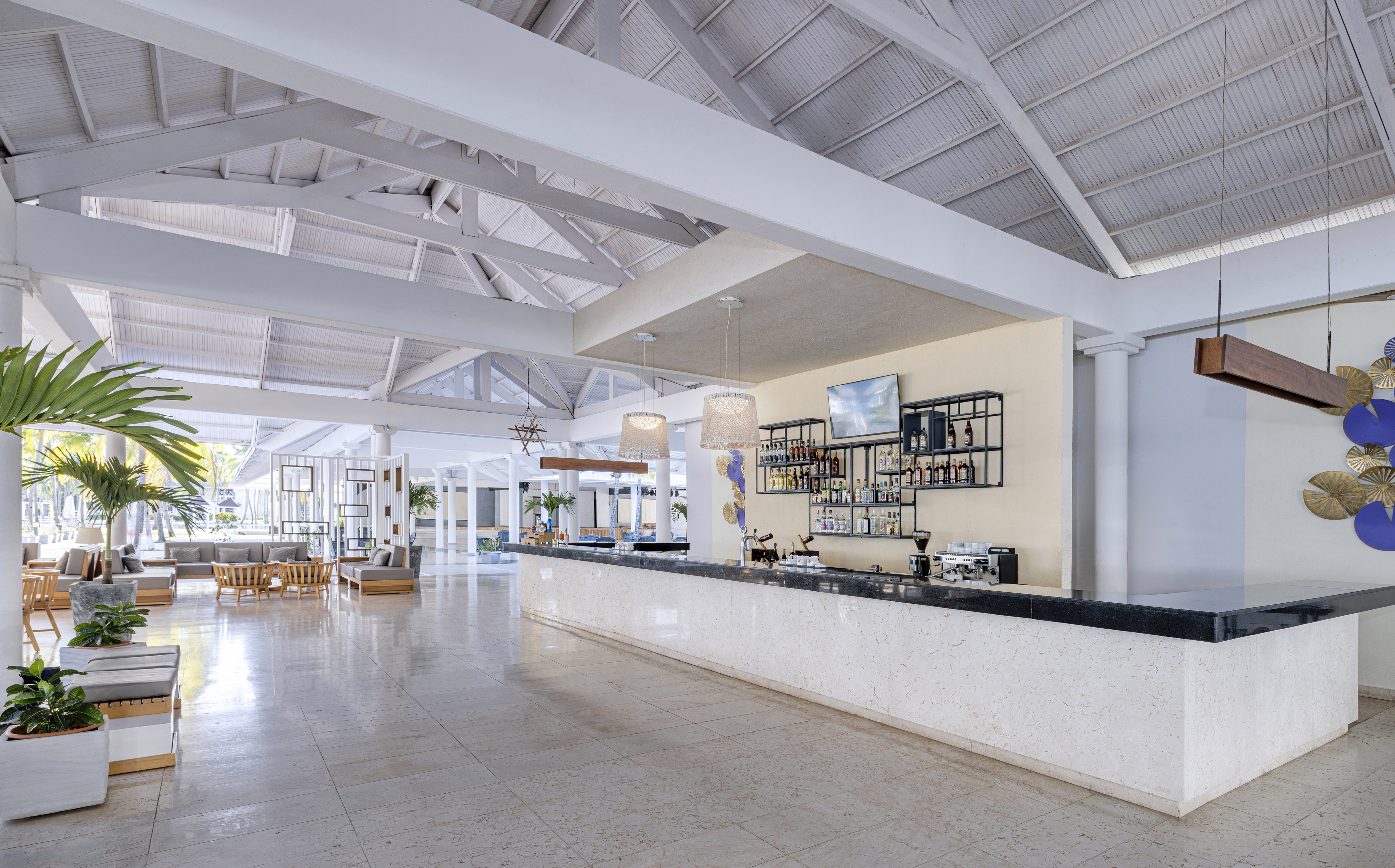a large white room with a bar and a large white ceiling