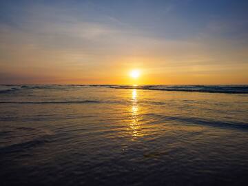 a sunset over a body of water