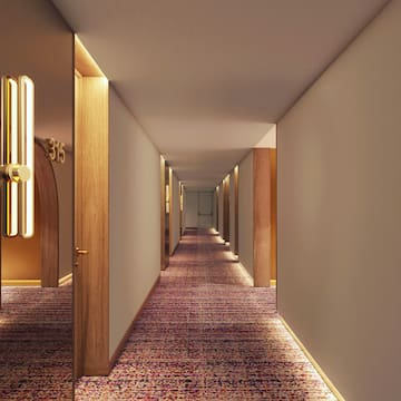 a hallway with a door and a carpeted floor