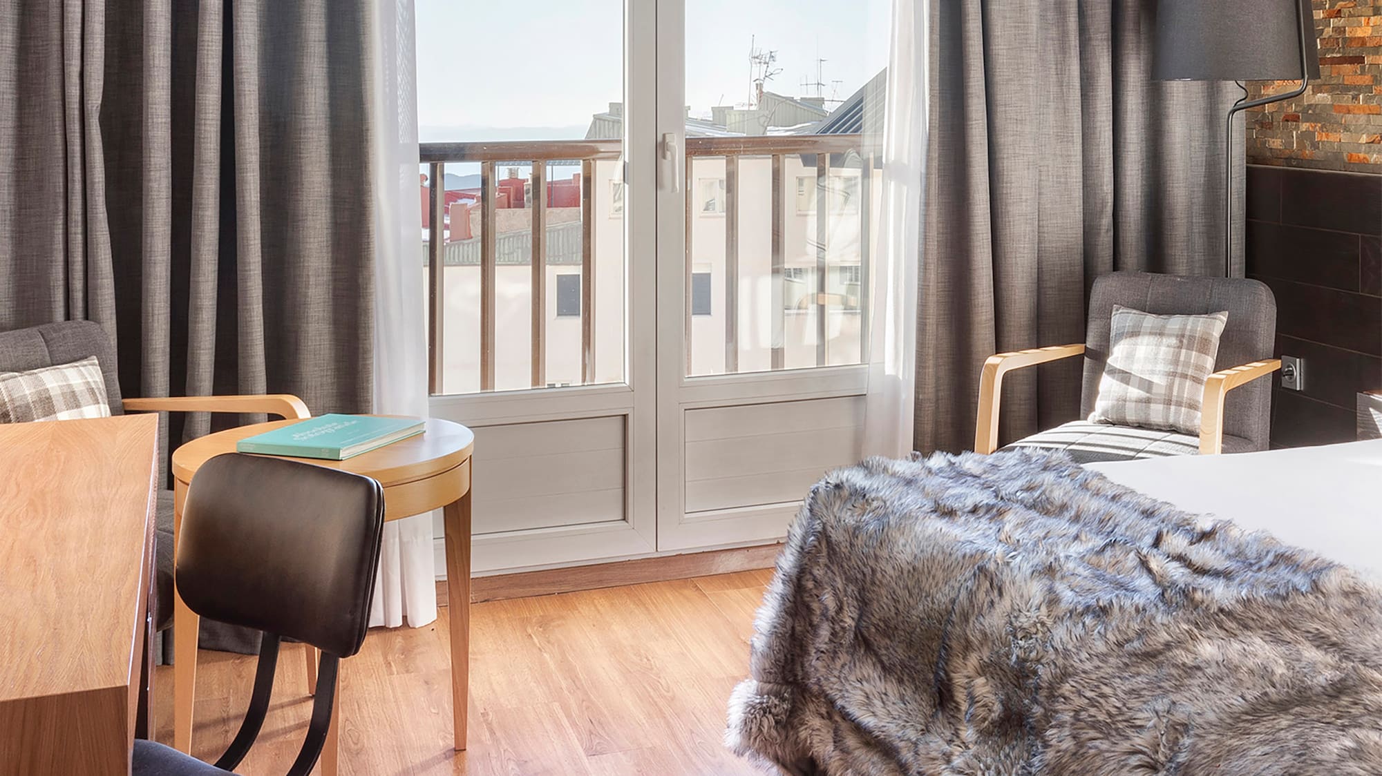 a bedroom with a bed and chairs and a table