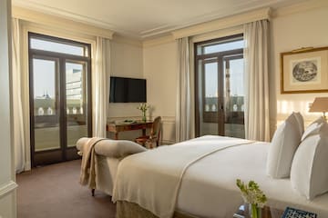 a bedroom with a bed and a desk and a television