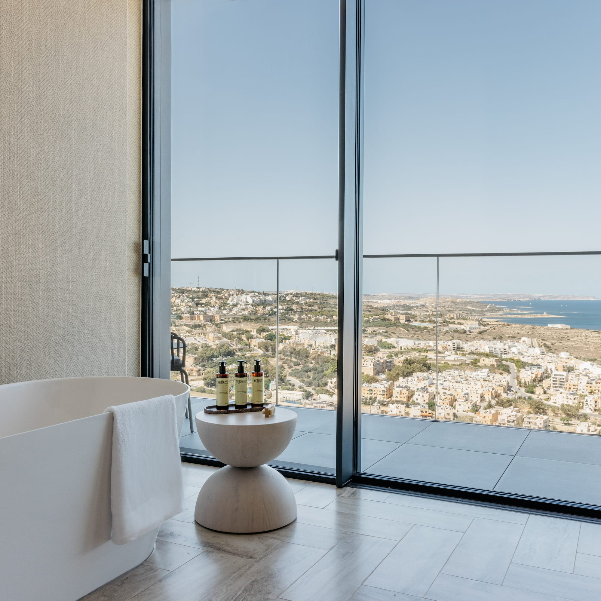 a bathroom with a tub and a bathtub overlooking a city