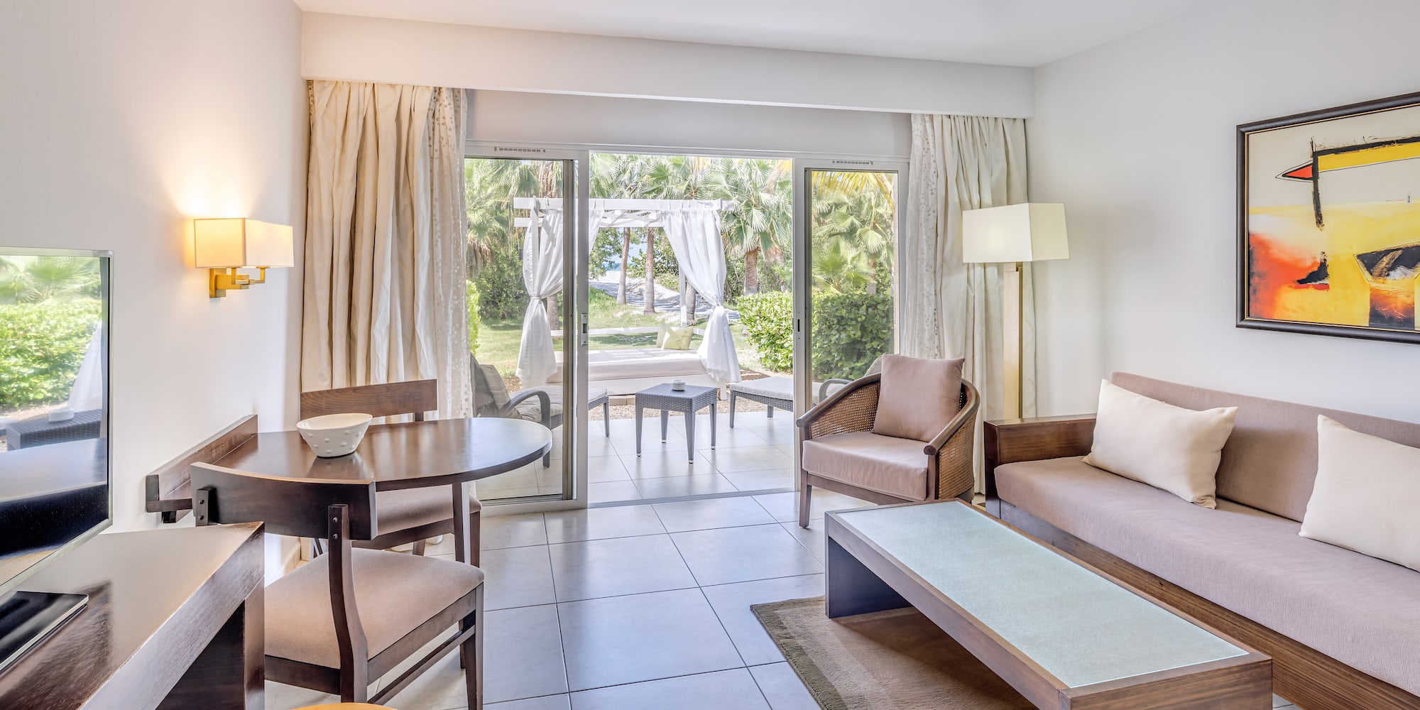 a living room with a table and chairs