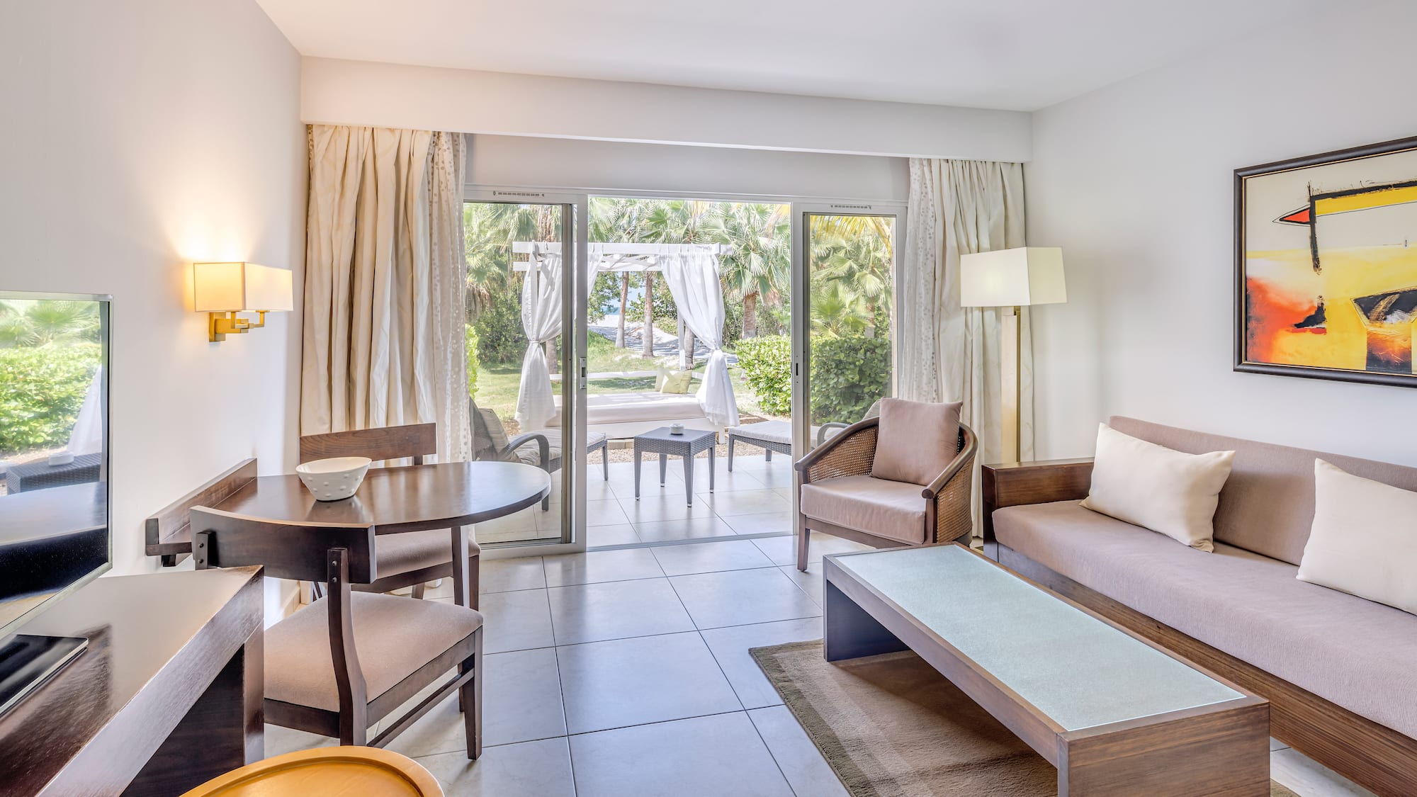 a living room with a table and chairs