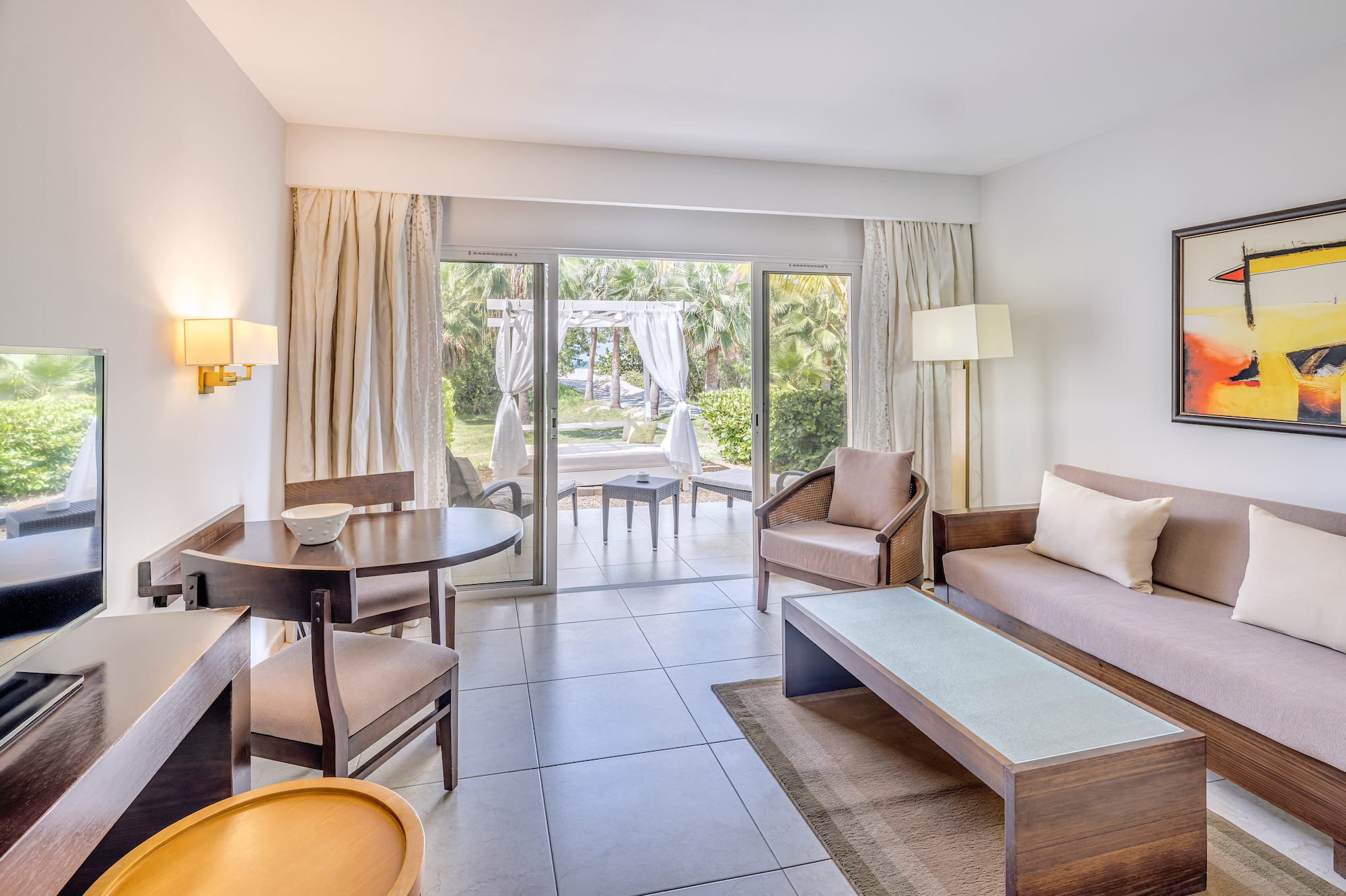 a living room with a table and chairs