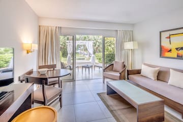a living room with a table and chairs