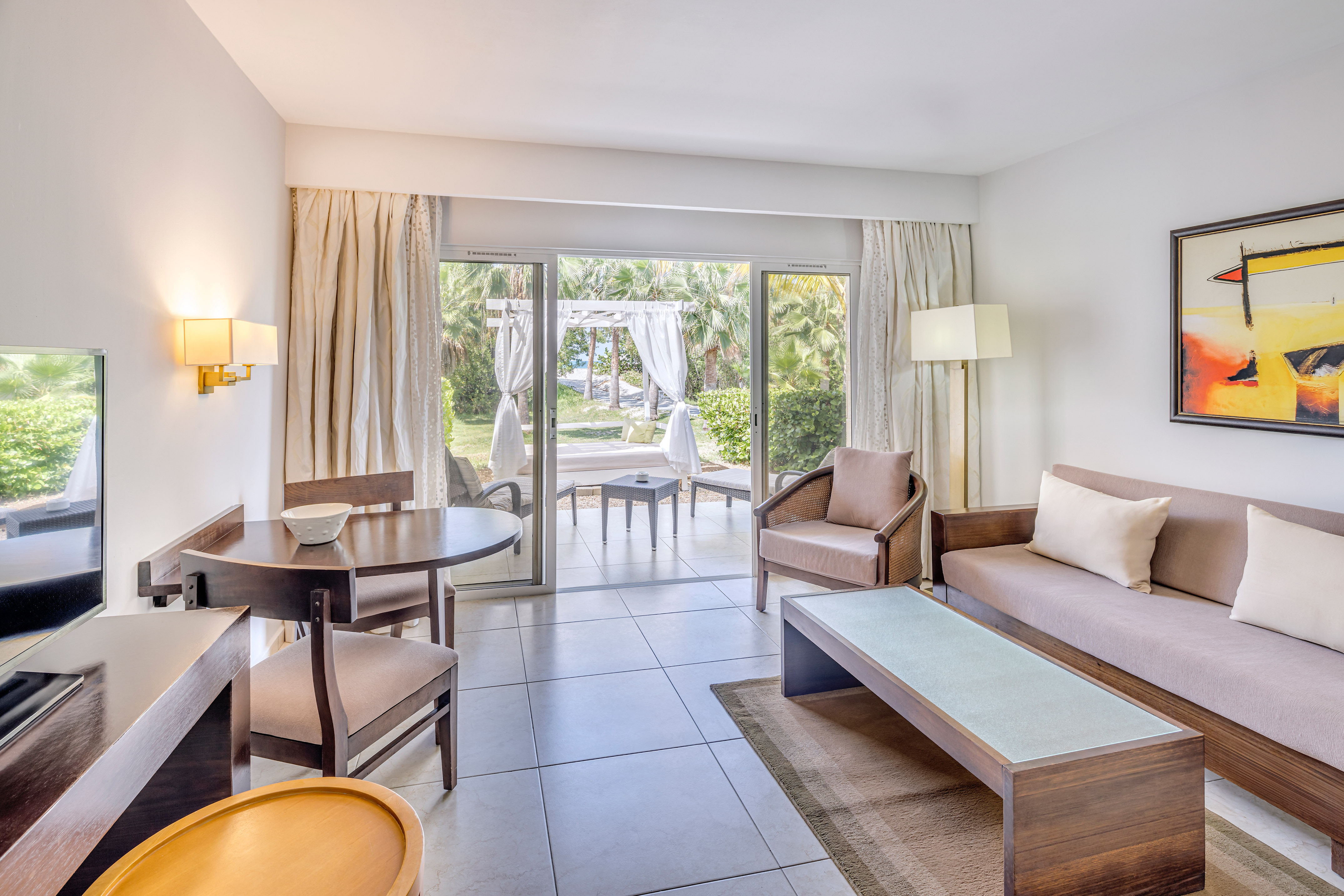 a living room with a table and chairs